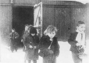 Soon after liberation, surviving children of the Auschwitz camp walk out of the children's barracks. Poland, after January 27, 1945.