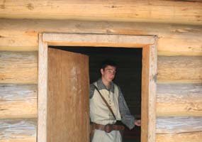 YCC student Roland standing in the doorway of Fort Clatsop